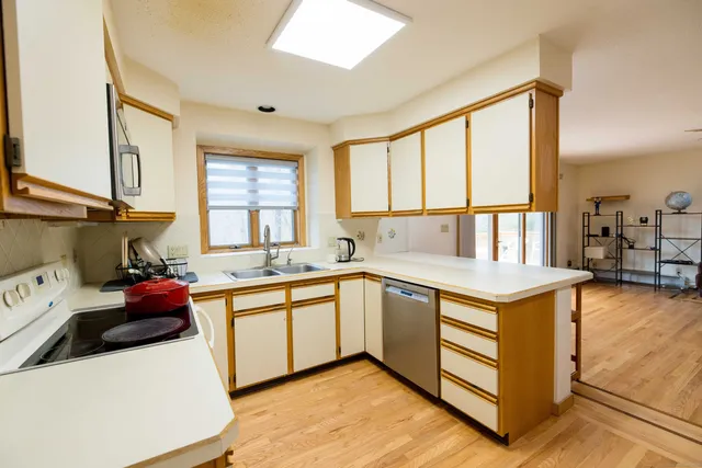 a kitchen with a sink stove and cabinets