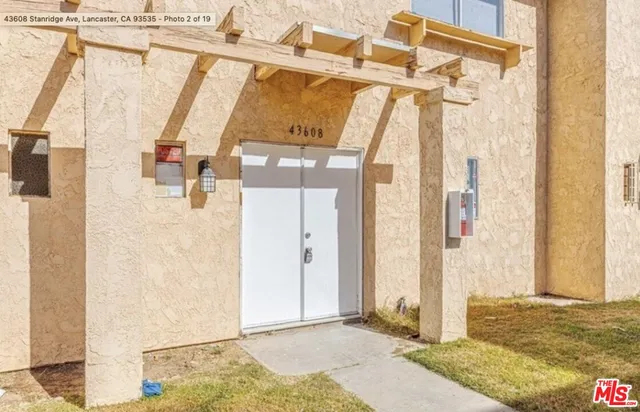 a bathroom with a granite countertop shower and a mirror