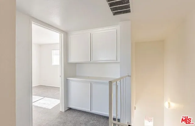 a kitchen with white cabinets