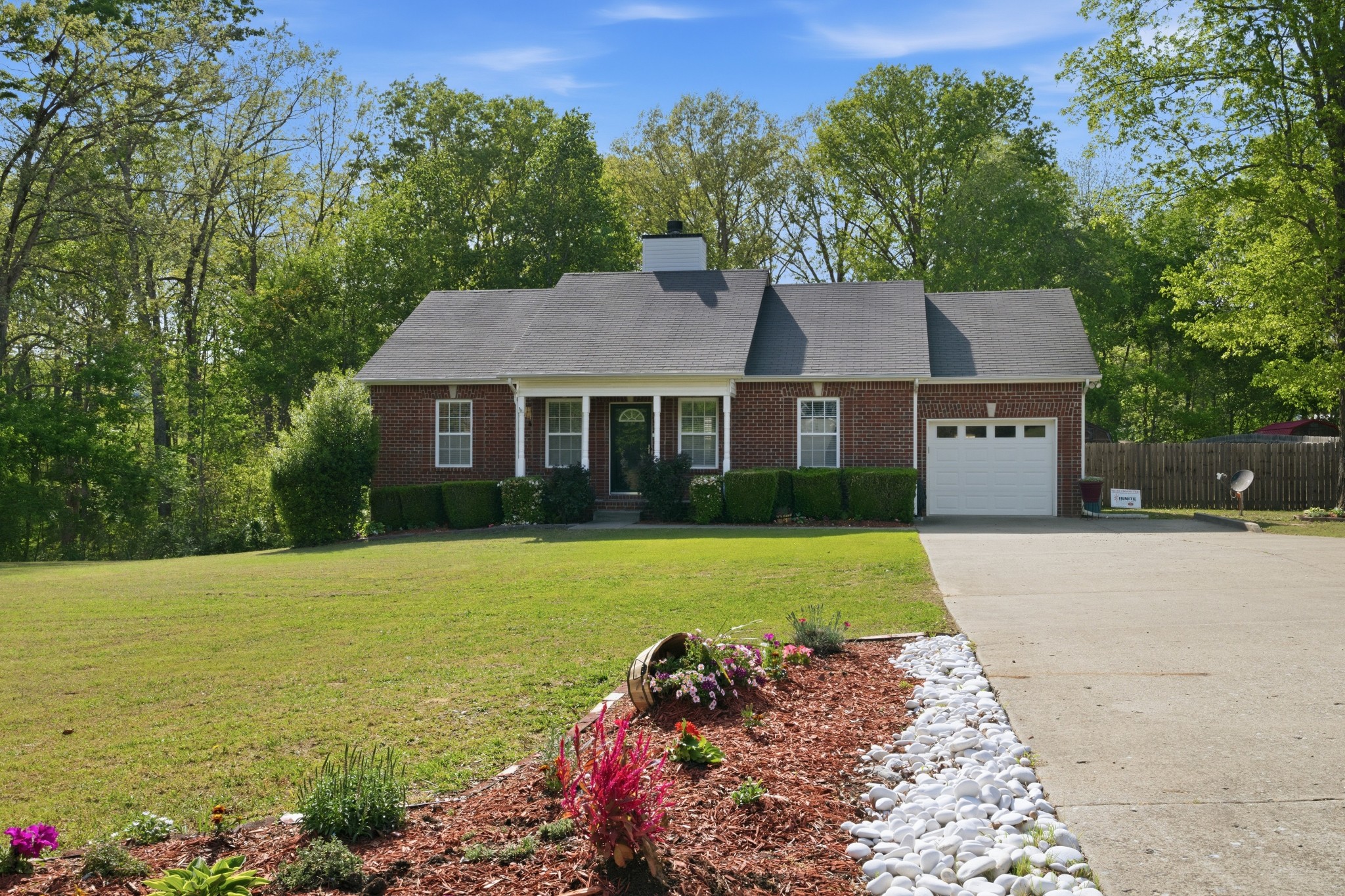 a front view of a house with a garden