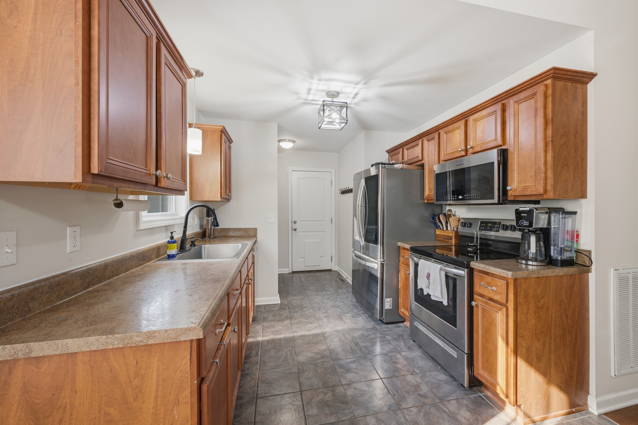 504 Daugherty Lane Burns, TN 37029 - Photo 15 of 30 a kitchen with stainless steel appliances granite countertop a sink stove and refrigerator