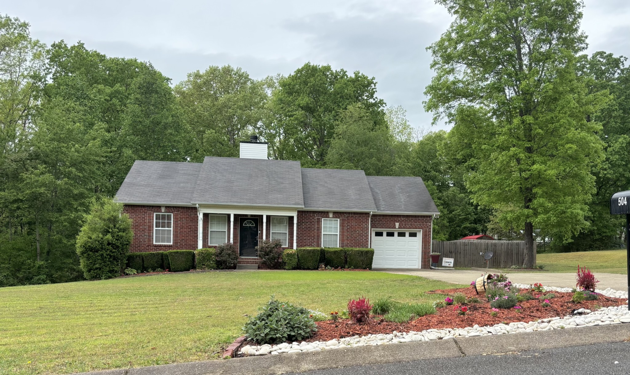 504 Daugherty Lane Burns, TN 37029 - Photo 2 of 30 a front view of a house with a yard and trees