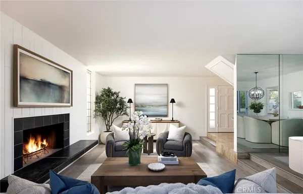 a living room with furniture potted plant and a fireplace