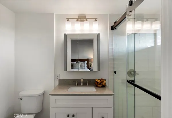 a bathroom with a sink toilet and mirror