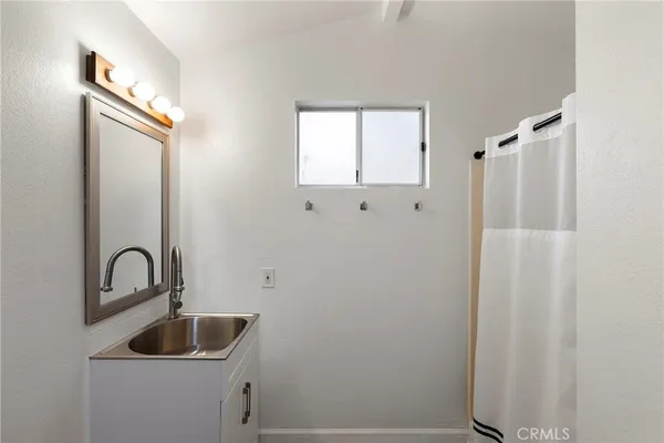 a bathroom with a sink and mirror