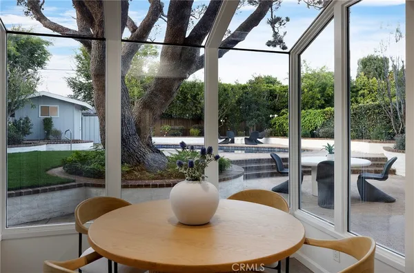 a dining room with glass windows and glass table