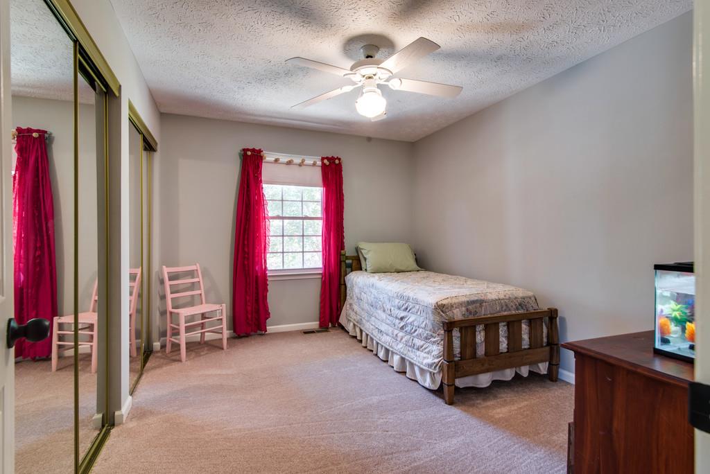 7315 Coldwater Road Fairview, TN 37062 - Photo 15 of 30 a living room with a bed furniture and a chandelier