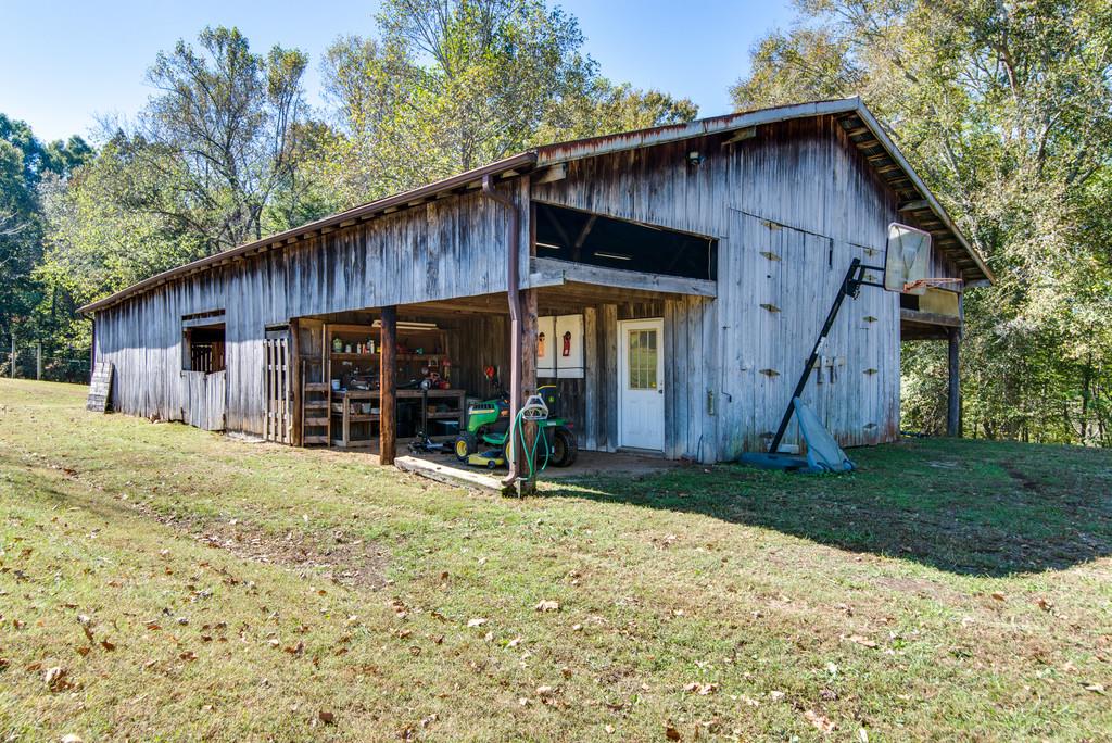 7315 Coldwater Road Fairview, TN 37062 - Photo 25 of 30 a backyard of a house with wooden fence and large trees