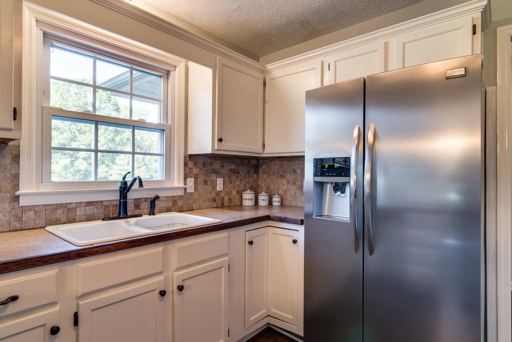 7315 Coldwater Road Fairview, TN 37062 - Photo 9 of 30 a kitchen with a refrigerator and a sink