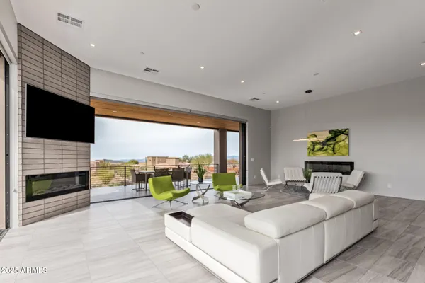 a kitchen with stainless steel appliances kitchen island granite countertop a table and chairs in it