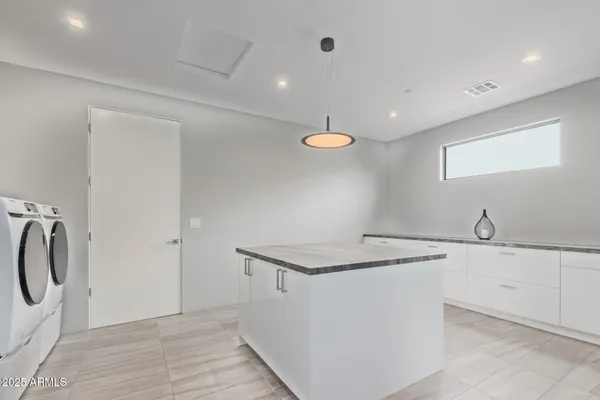 a view of a hall with stairs and wooden floor