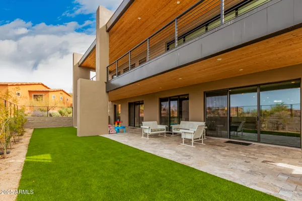 a view of a house with swimming pool and porch with furniture
