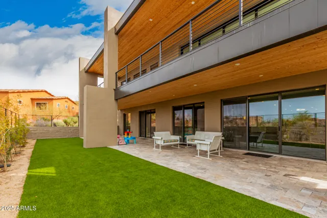 a view of a house with swimming pool and porch with furniture