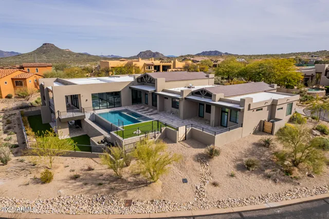 an aerial view of a house with swimming pool