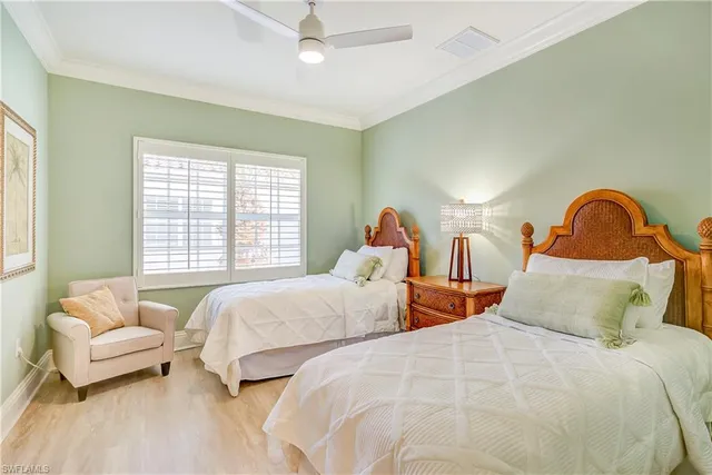 a bedroom with two beds and a couch