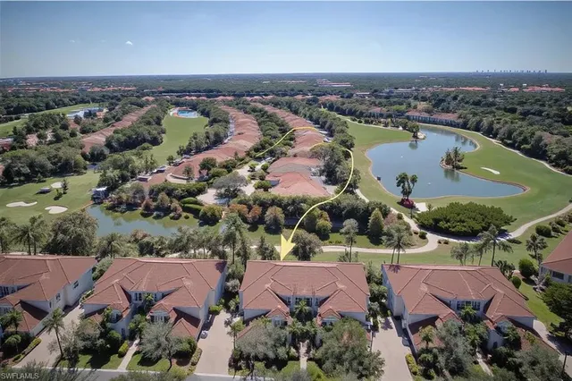 an aerial view of a city with lots of residential buildings lake and ocean view