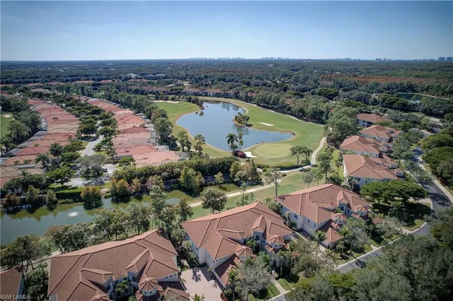an aerial view of residential houses with outdoor space and swimming pool