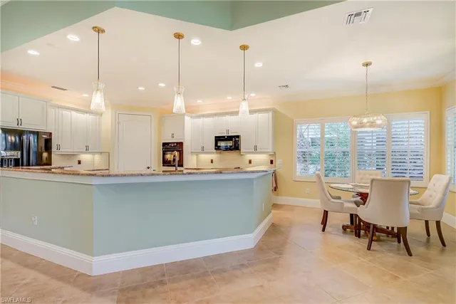 a view of a dining room with furniture large windows and wooden floor