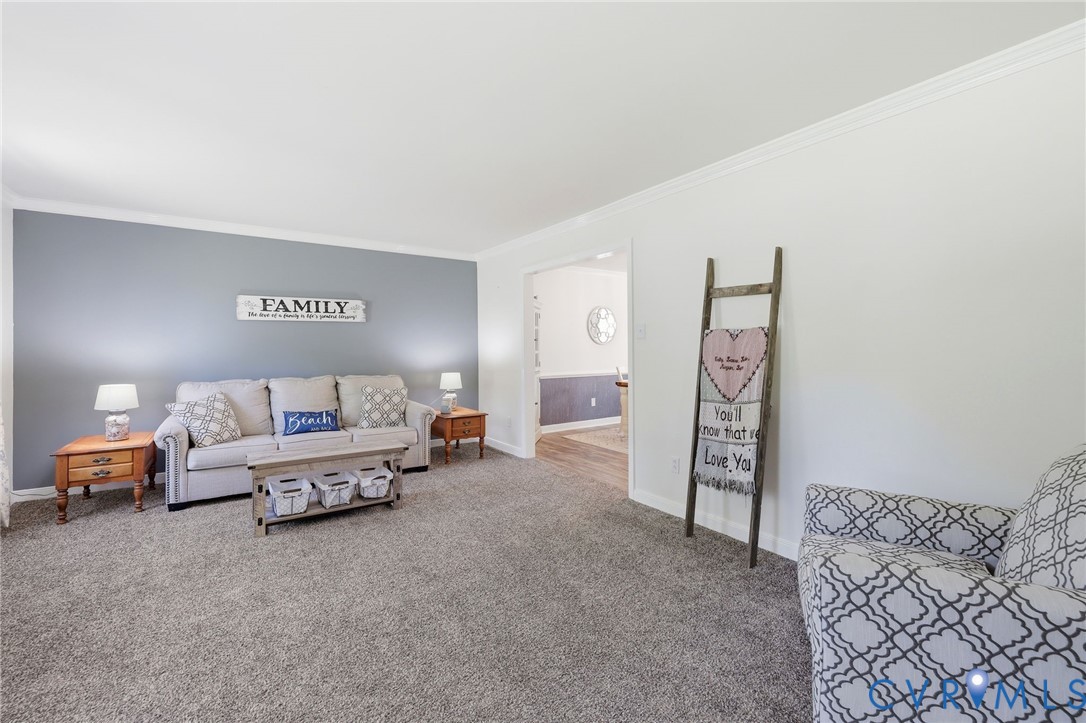 11200 Surry Road Chester, VA 23831 - Photo 10 of 48 a spacious bedroom with a bed and a couch