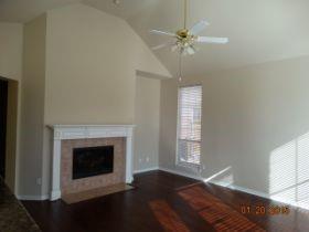 3104 Angus Drive Plano, TX 75025 - Photo 9 of 35 a view of an empty room with a fireplace and a window