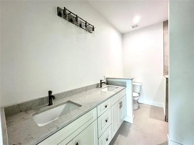 a bathroom with a sink and mirror