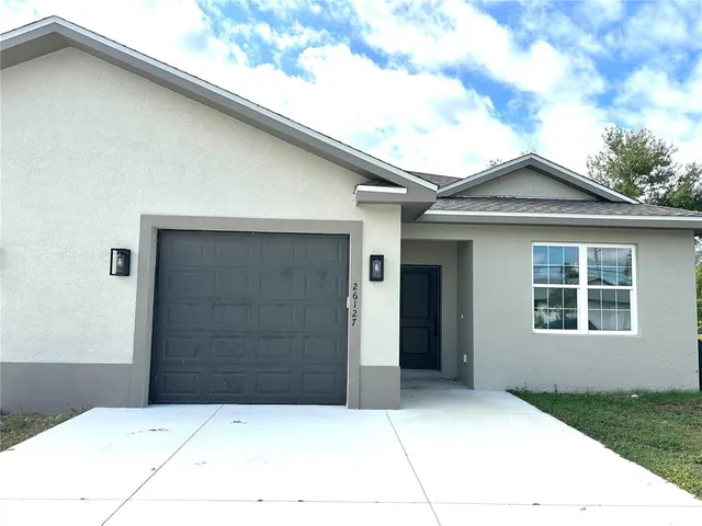 a front view of a house with a garage