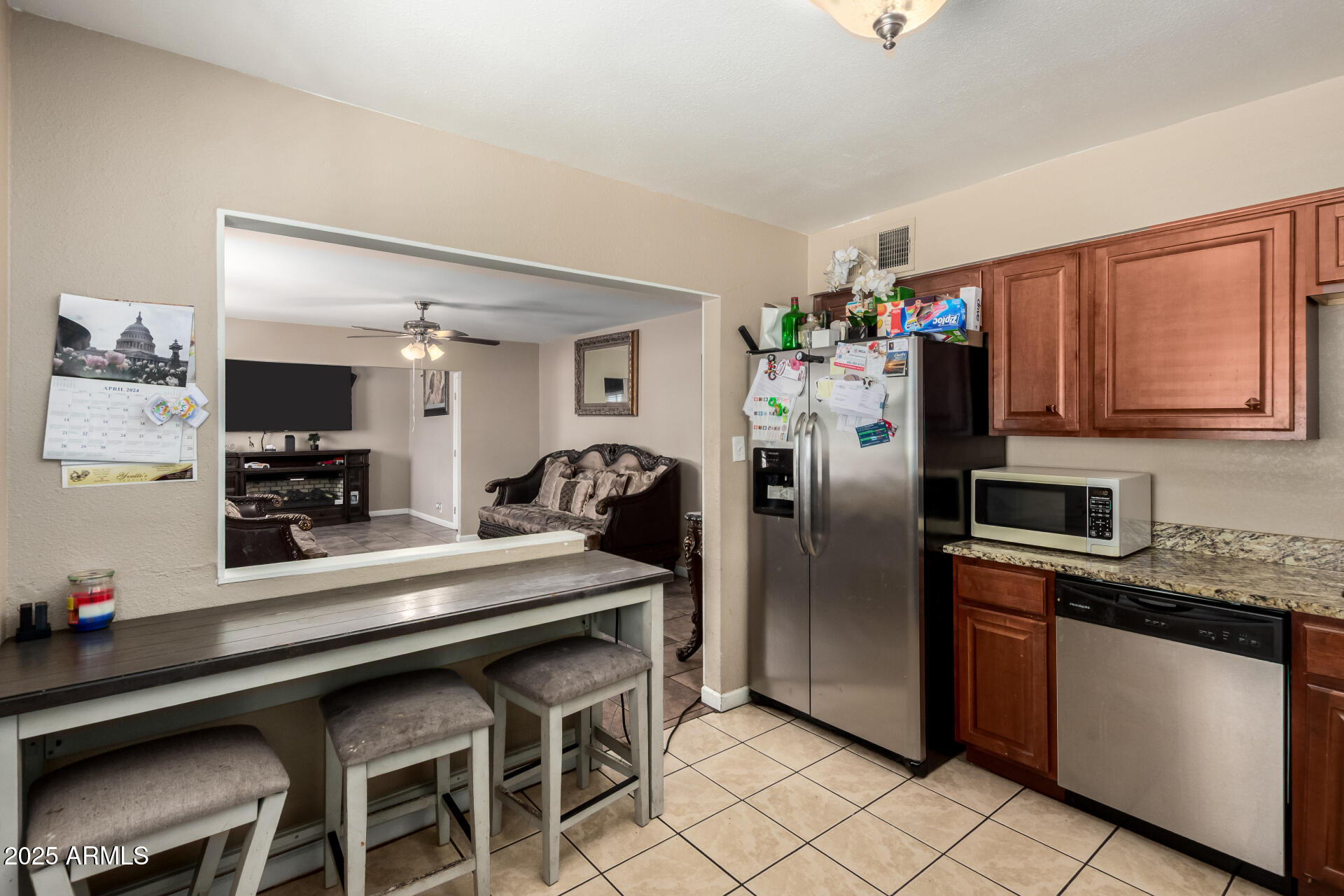 3152 North 24th Drive Phoenix, AZ 85015 - Photo 13 of 28 a kitchen with stainless steel appliances granite countertop a refrigerator and a stove top oven