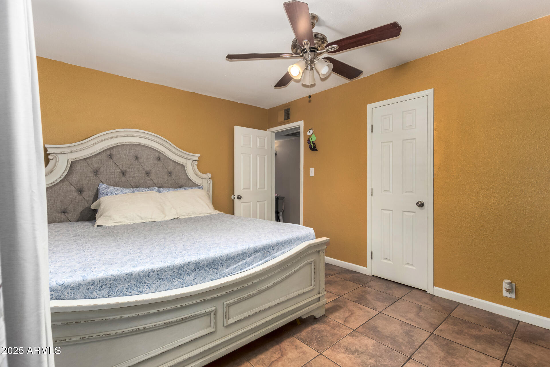 3152 North 24th Drive Phoenix, AZ 85015 - Photo 15 of 28 a bedroom with a bed and a ceiling fan
