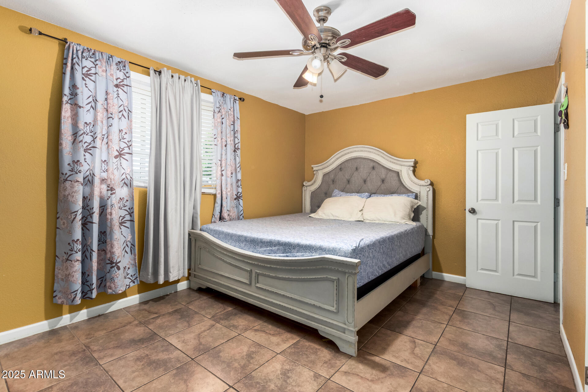 3152 North 24th Drive Phoenix, AZ 85015 - Photo 16 of 28 a bedroom with a bed and a chandelier