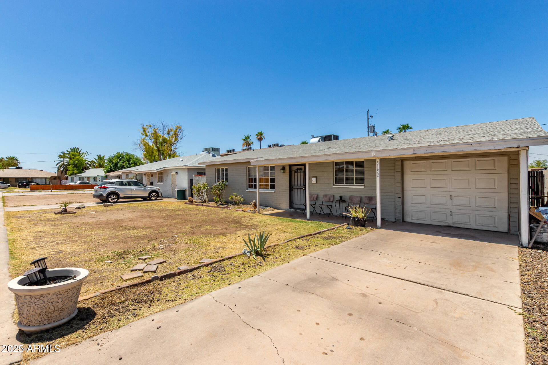 3152 North 24th Drive Phoenix, AZ 85015 - Photo 2 of 28 a front view of a house with a yard