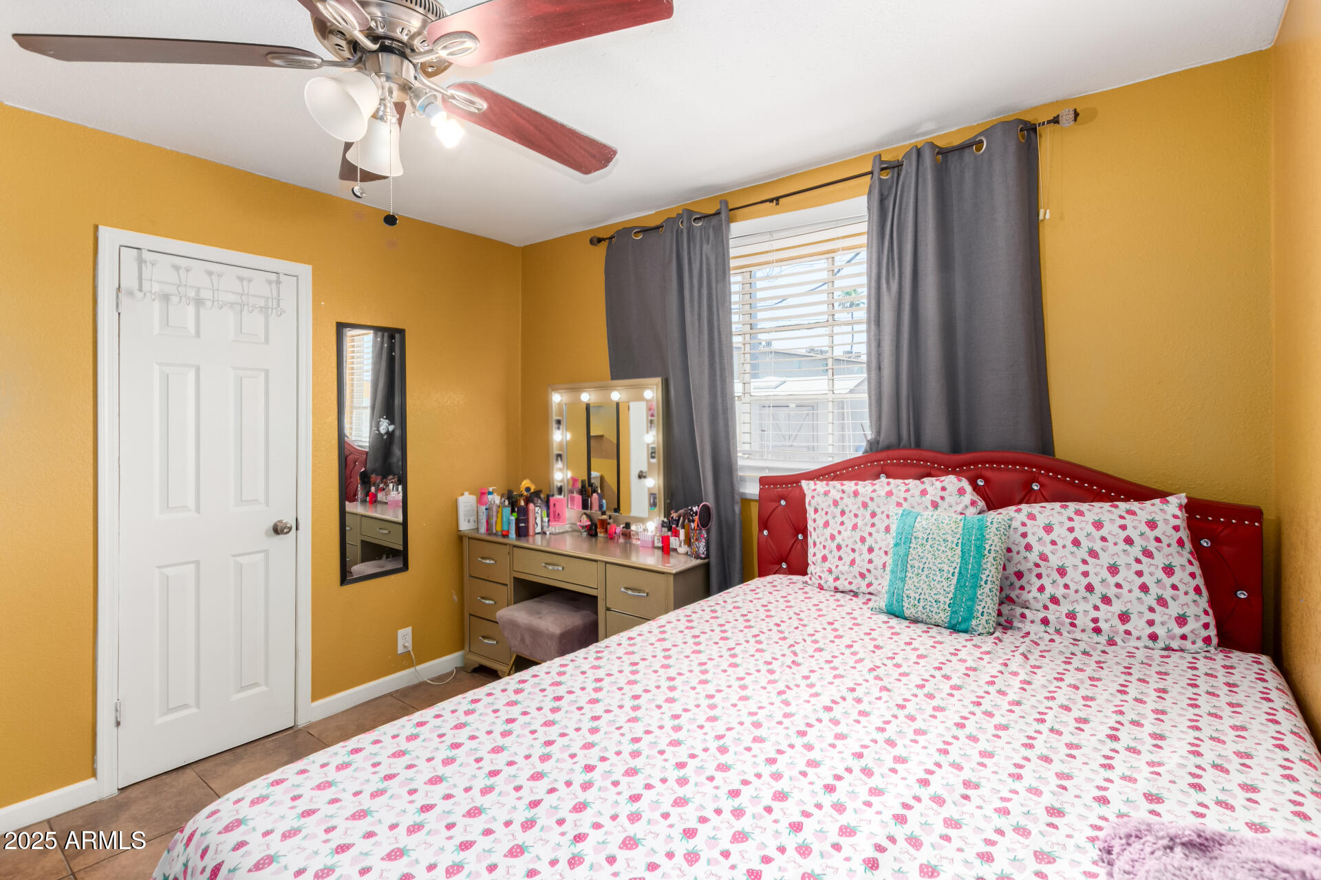 3152 North 24th Drive Phoenix, AZ 85015 - Photo 21 of 28 a bedroom with a large bed and a chandelier