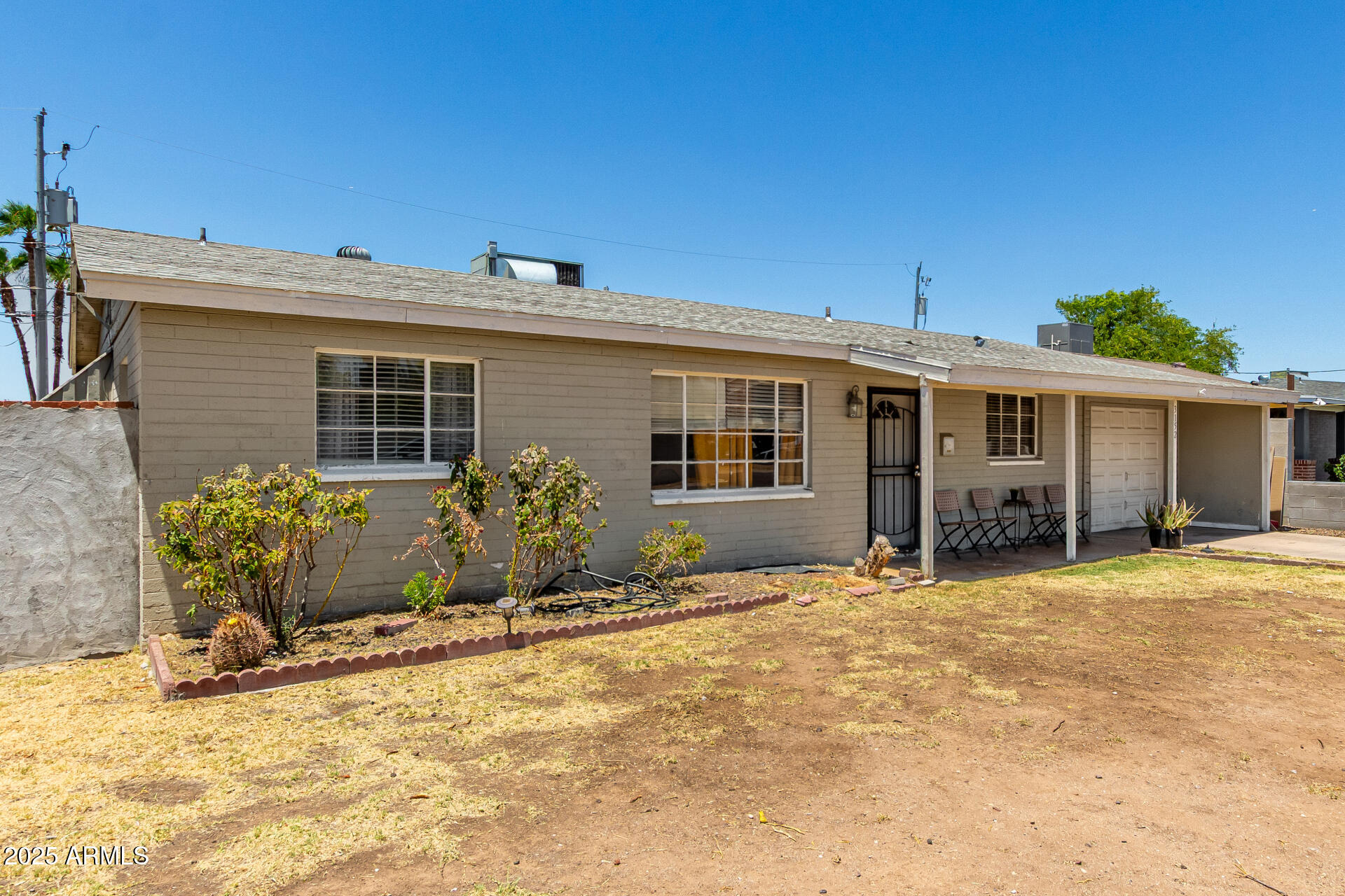 3152 North 24th Drive Phoenix, AZ 85015 - Photo 5 of 28 a front view of a house with a garden