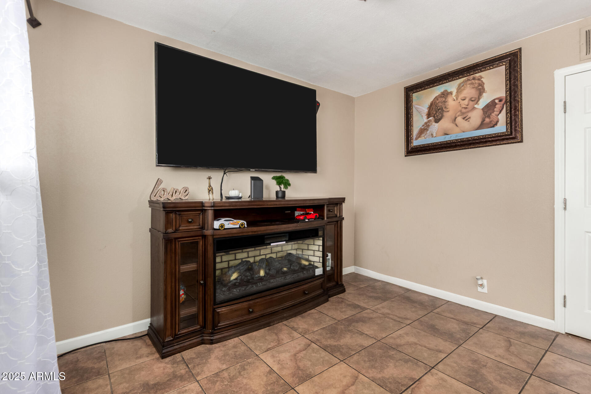 3152 North 24th Drive Phoenix, AZ 85015 - Photo 6 of 28 a living room with a flat screen tv and a fireplace