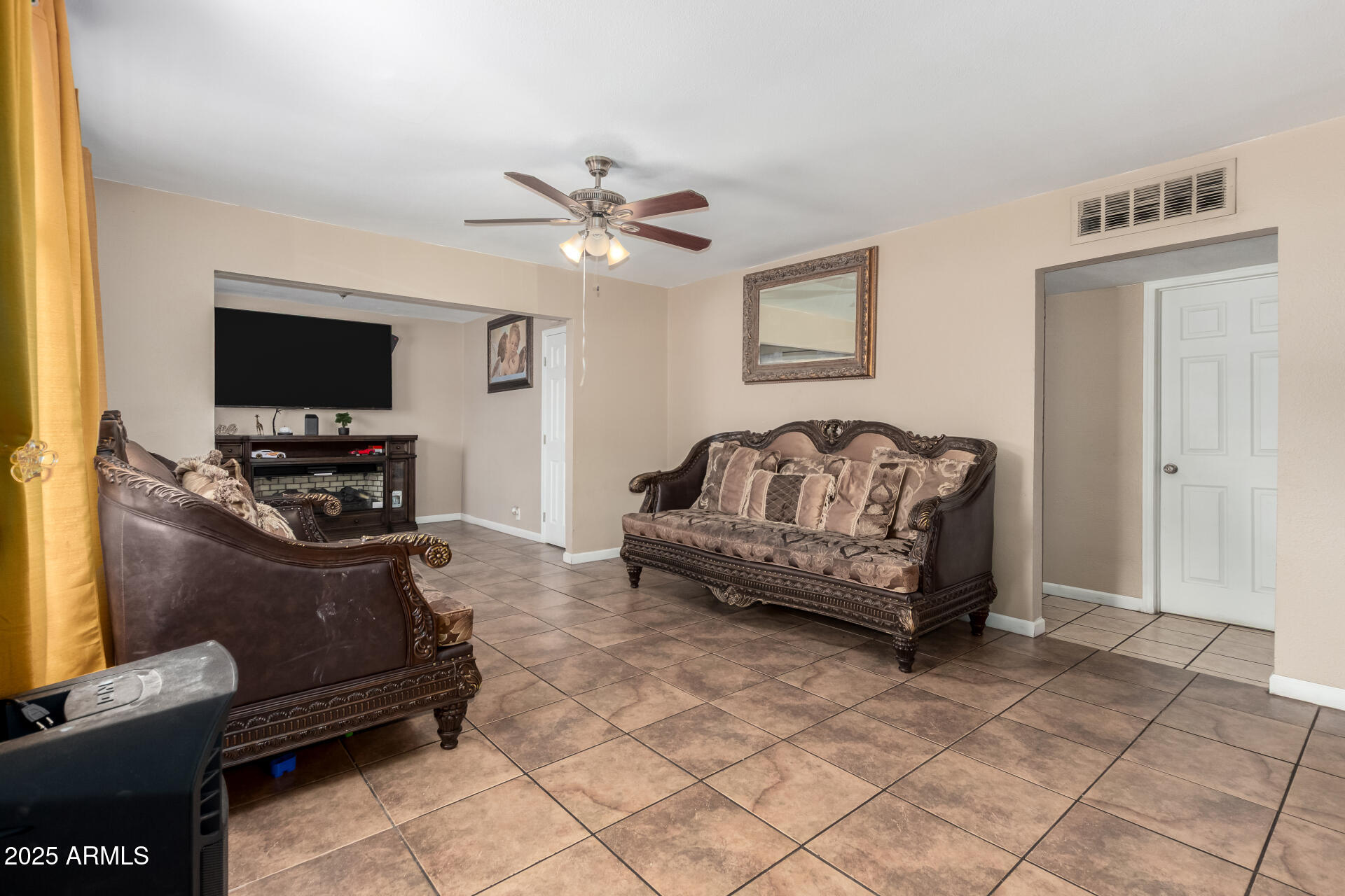 3152 North 24th Drive Phoenix, AZ 85015 - Photo 8 of 28 a living room with furniture and a flat screen tv