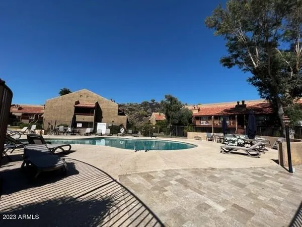 a view of a building with sitting area and furniture