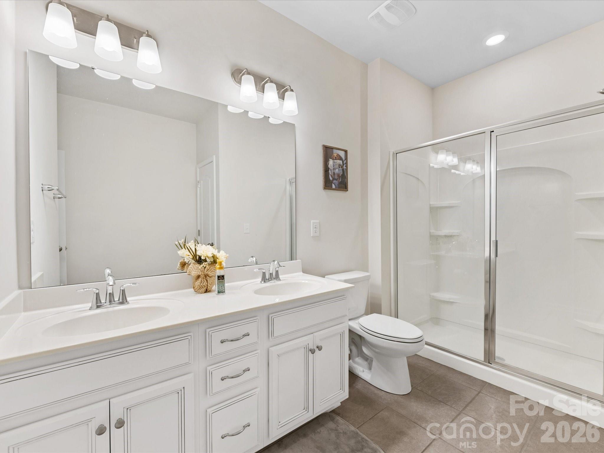 4261 Coachwhip Avenue Lancaster, SC 29720 - Photo 17 of 42 a bathroom with a double vanity sink toilet mirror and shower