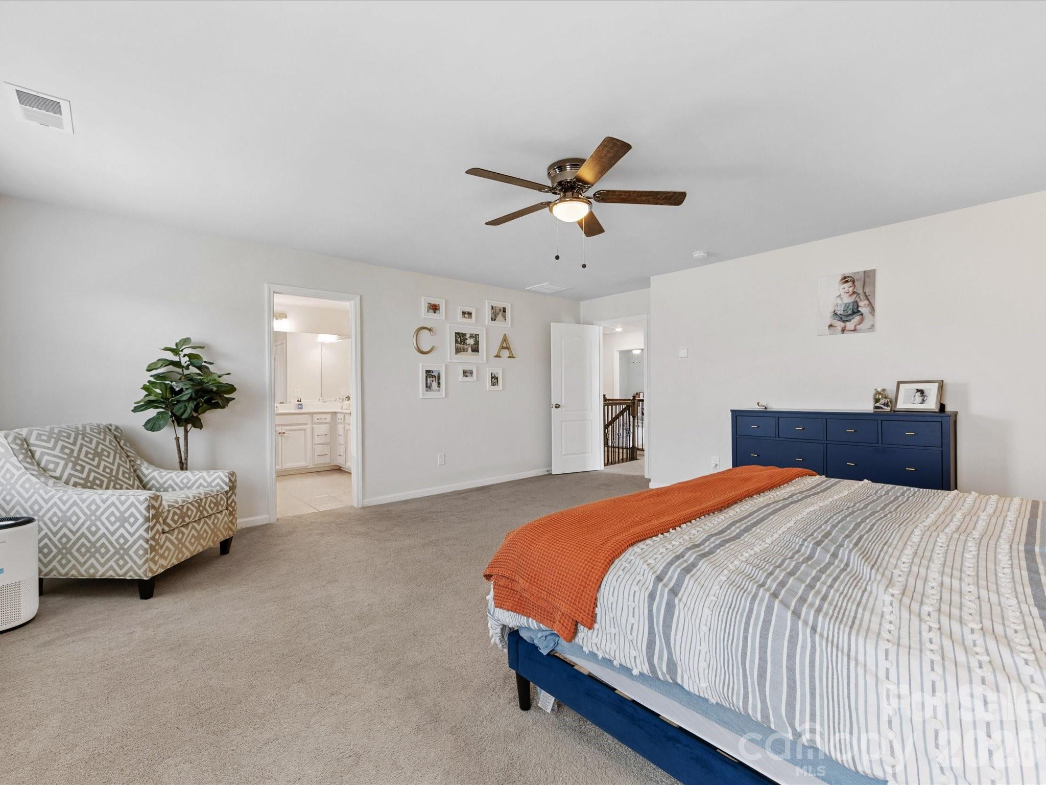 4261 Coachwhip Avenue Lancaster, SC 29720 - Photo 24 of 42 a bedroom with a bed furniture and a chandelier