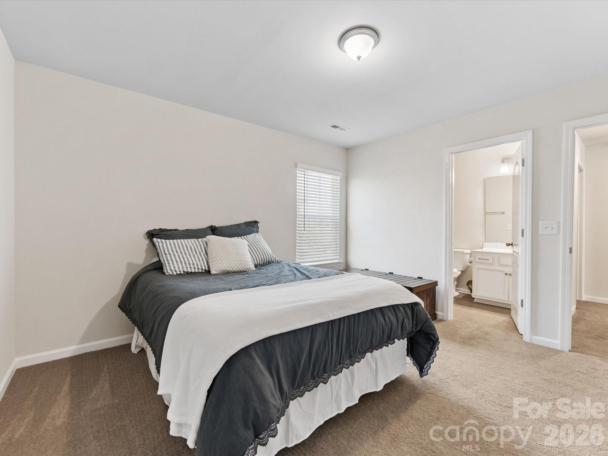 4261 Coachwhip Avenue Lancaster, SC 29720 - Photo 32 of 42 a bedroom with a bed and a view of bathroom