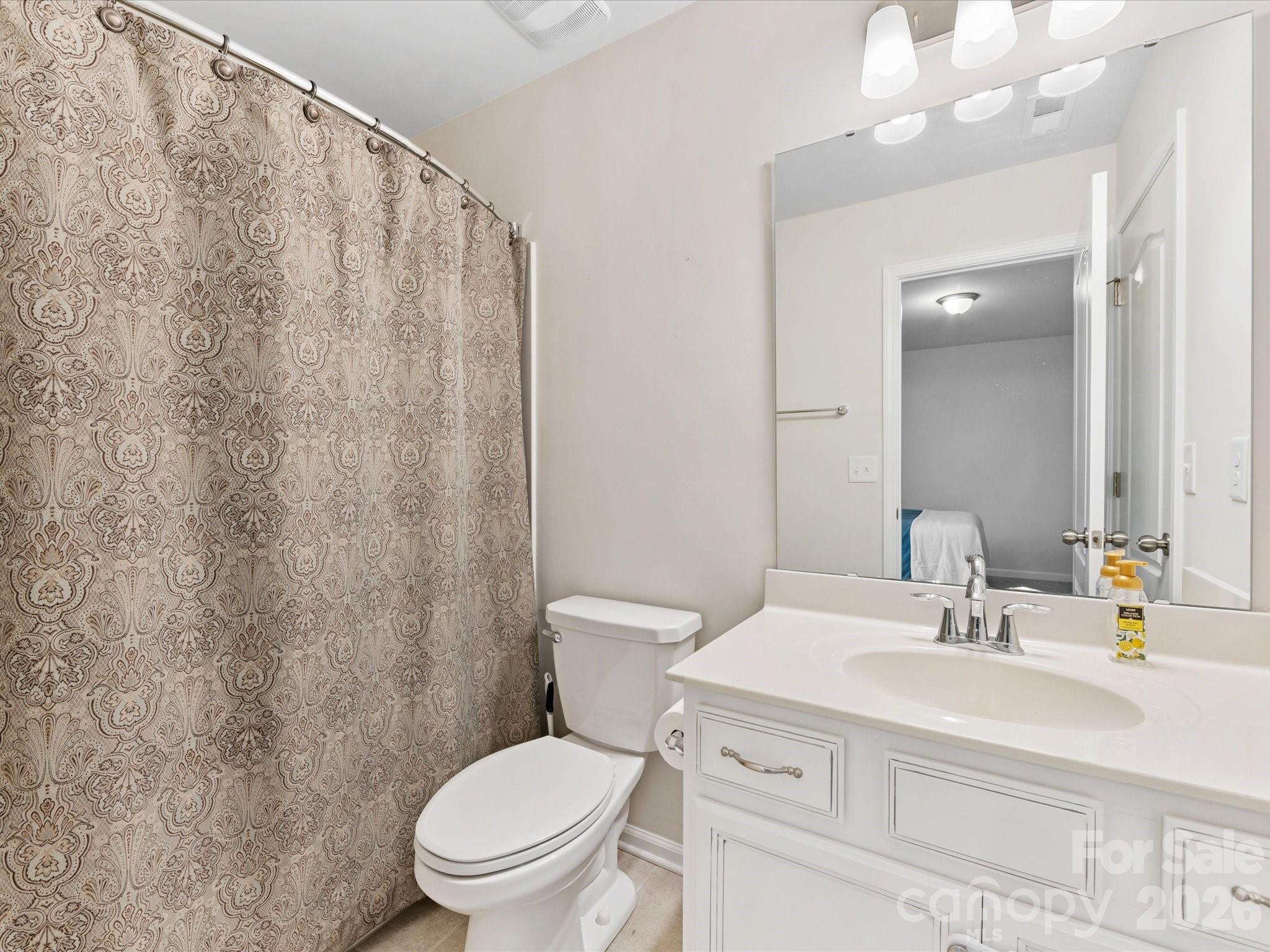 4261 Coachwhip Avenue Lancaster, SC 29720 - Photo 33 of 42 a bathroom with a toilet a sink and a mirror