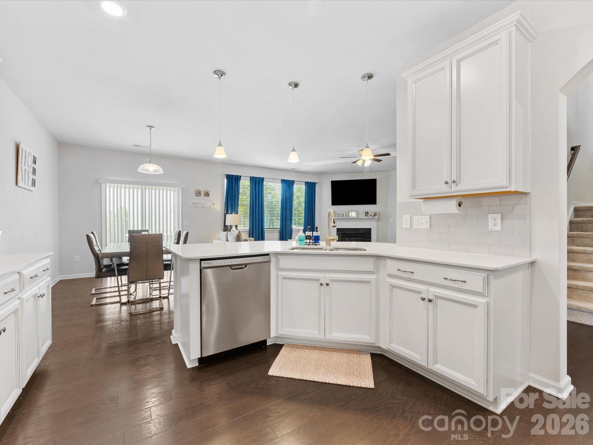 4261 Coachwhip Avenue Lancaster, SC 29720 - Photo 4 of 42 a open white kitchen with cabinets a sink and chairs