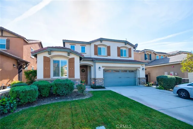 a front view of a house with a yard and garage