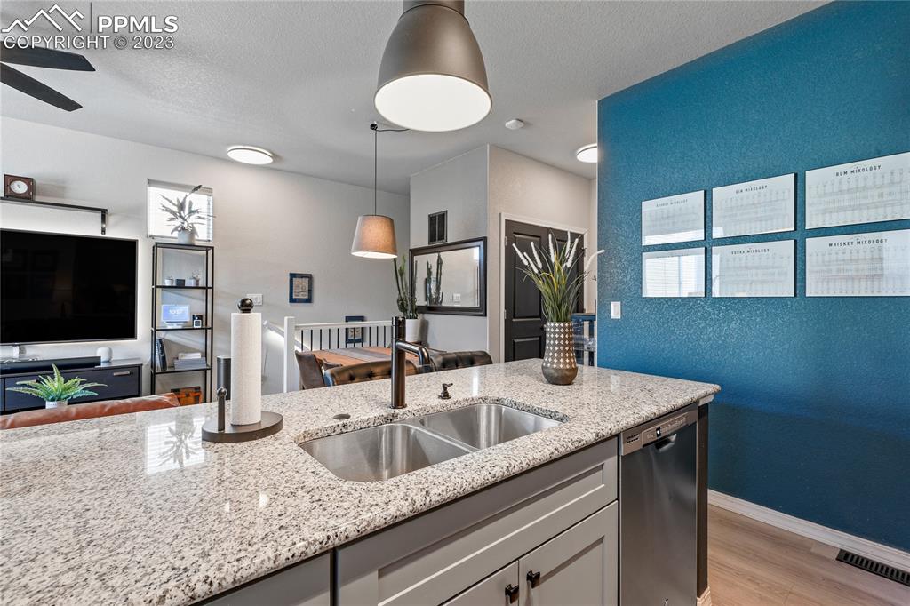 2016 Paddy Grove Colorado Springs, CO 80910 - Photo 14 of 39 a kitchen with a sink and a wooden floor