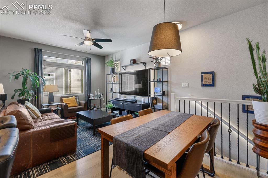 2016 Paddy Grove Colorado Springs, CO 80910 - Photo 16 of 39 a living room with furniture a table and chairs