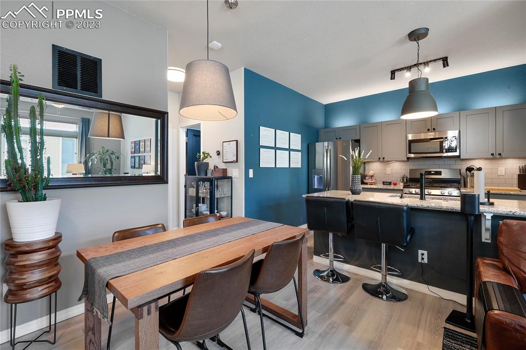 2016 Paddy Grove Colorado Springs, CO 80910 - Photo 18 of 39 a kitchen with a dining table chairs and refrigerator