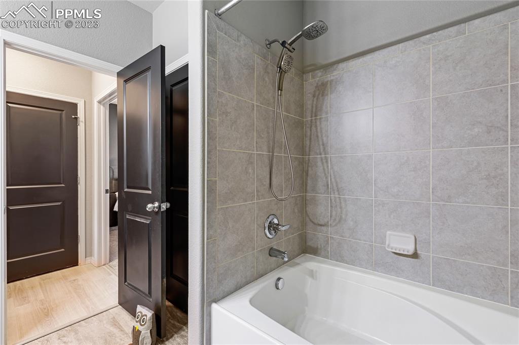 2016 Paddy Grove Colorado Springs, CO 80910 - Photo 26 of 39 a bathroom with a bathtub and a shower