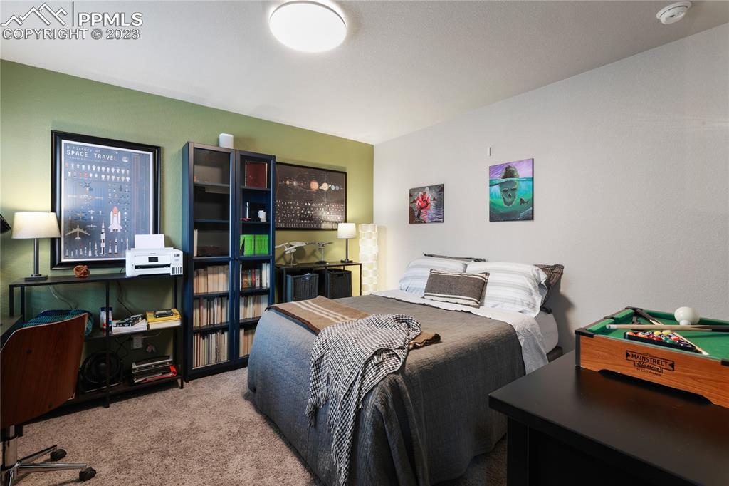 2016 Paddy Grove Colorado Springs, CO 80910 - Photo 27 of 39 a bedroom with a bed and a couch