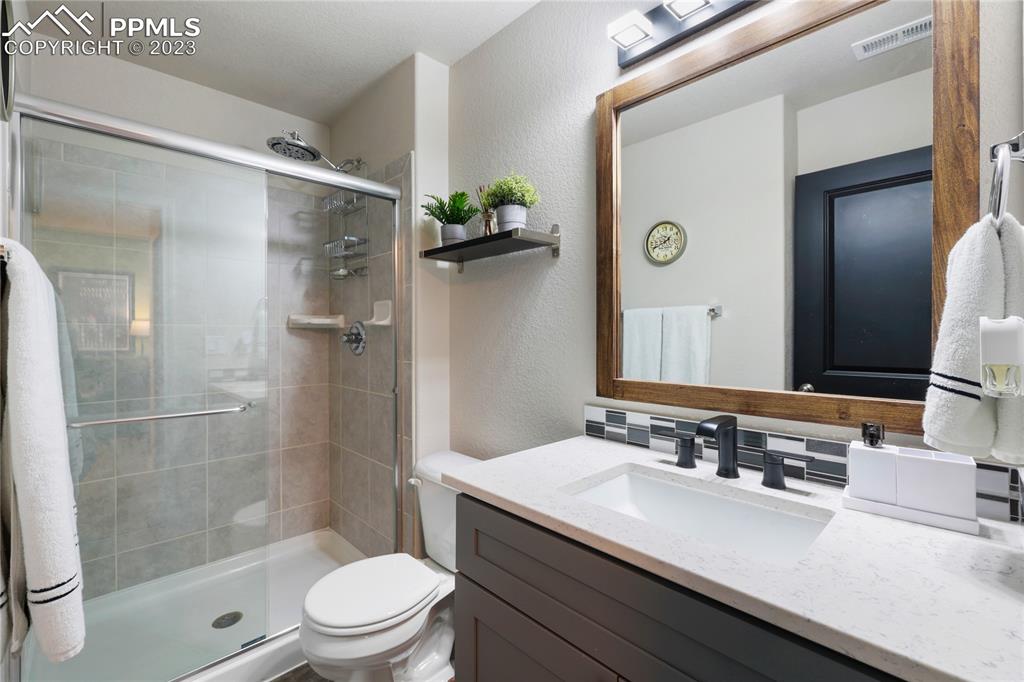 2016 Paddy Grove Colorado Springs, CO 80910 - Photo 31 of 39 a bathroom with a sink toilet and shower