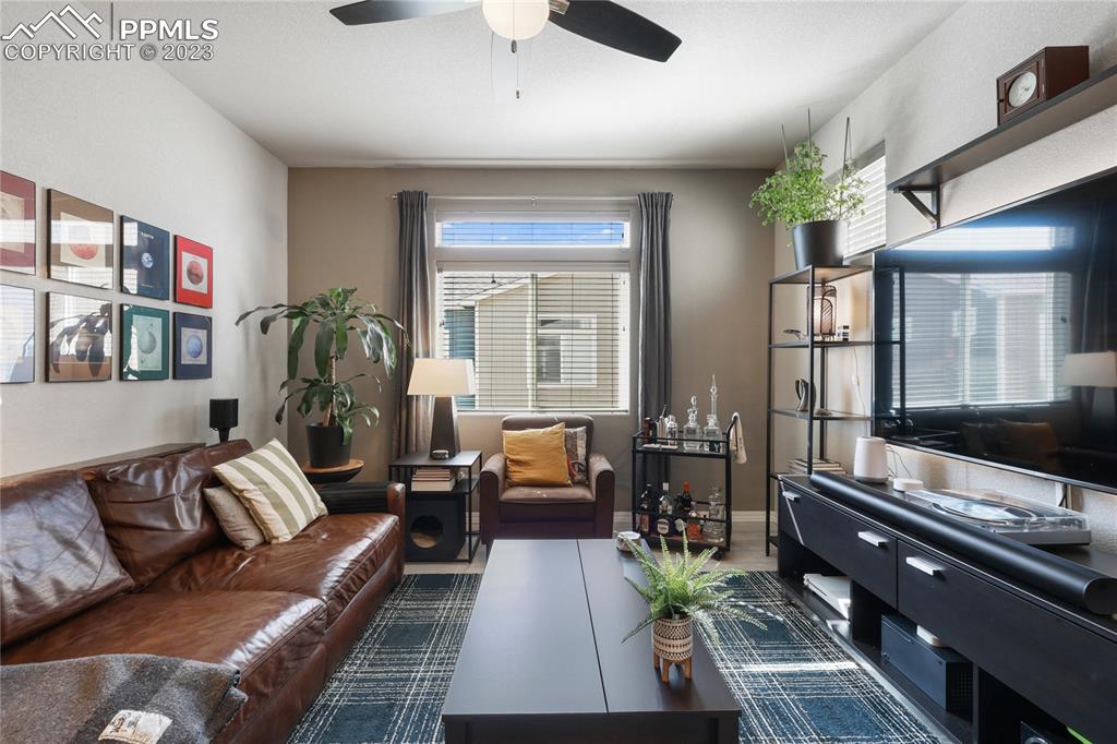 2016 Paddy Grove Colorado Springs, CO 80910 - Photo 8 of 39 a living room with furniture and a flat screen tv