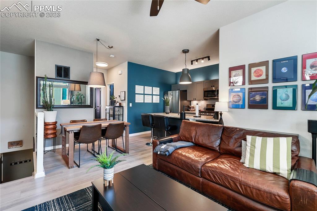 2016 Paddy Grove Colorado Springs, CO 80910 - Photo 10 of 39 a living room with furniture kitchen view and a wooden floor