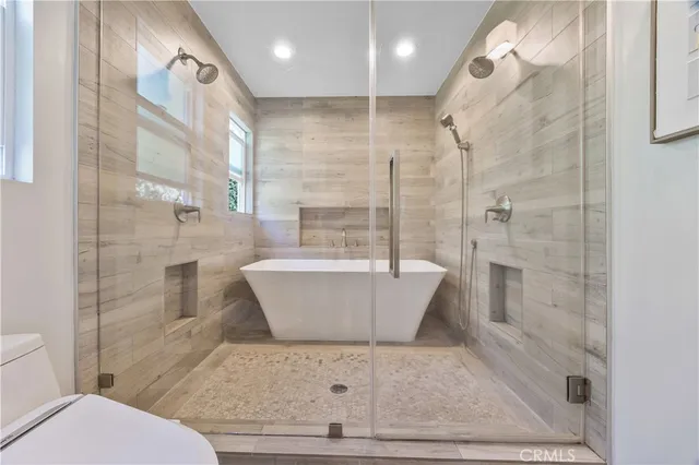 a bathroom with a bathtub and shower